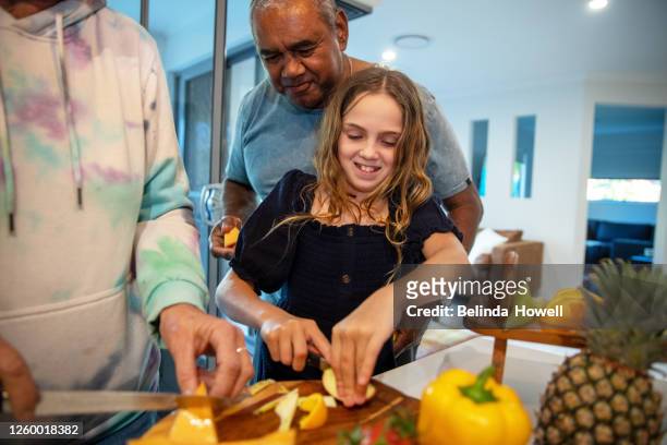 multigenerational aboriginal family spends time together in the family home - australian family time stockfoto's en -beelden