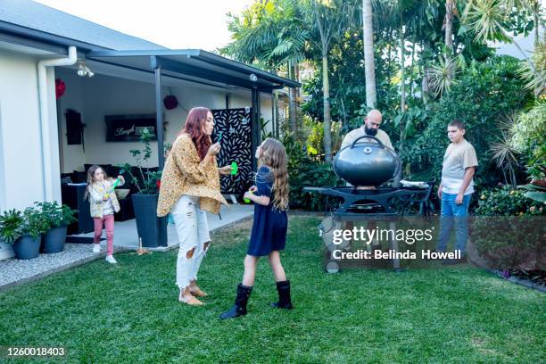 multigenerational aboriginal family spends time together in the family home - australian bbq stock-fotos und bilder