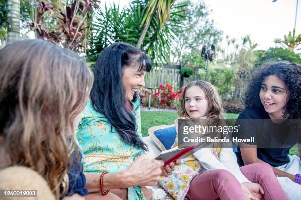 multigenerational aboriginal family spends time together in the family home - australian culture stock photos et images de collection