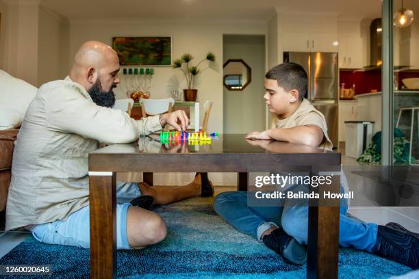 multigenerational aboriginal family spends time together in the family home - australian family time stock-fotos und bilder