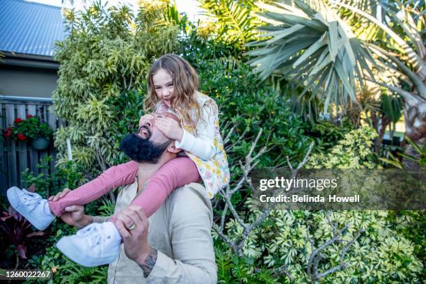 multigenerational aboriginal family spends time together in the family home - australian family time stockfoto's en -beelden