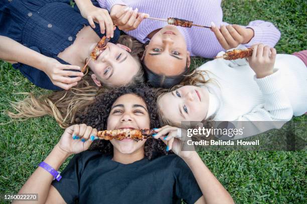 multigenerational aboriginal family spends time together in the family home - cousins stockfoto's en -beelden