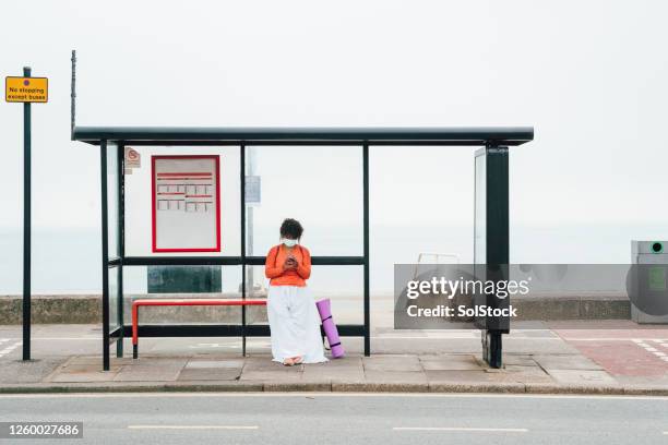 waiting for the bus - bus stop uk stock pictures, royalty-free photos & images