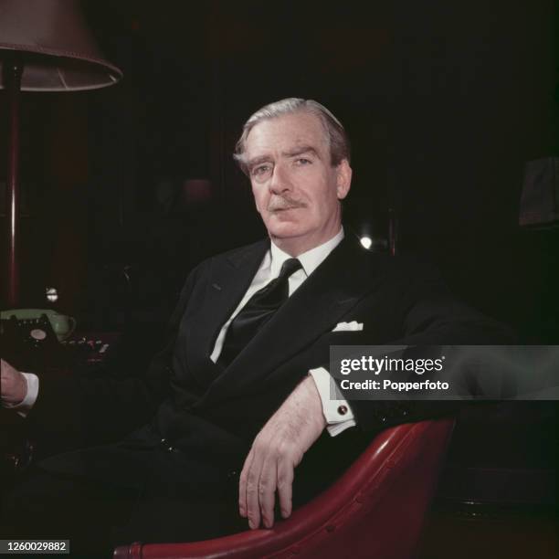 British Conservative Party politician, Foreign Secretary and deputy Prime Minister of the United Kingdom, Sir Anthony Eden posed seated in an...