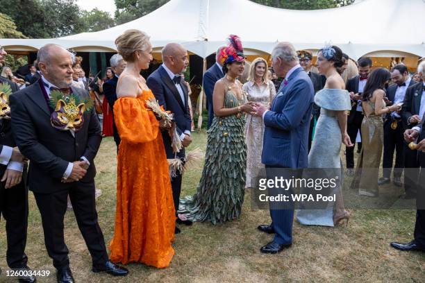 King Charles III speaks with a guest as Christian Louboutin and Kristin Scott Thomas look on during the Animal Ball at Lancaster House to mark the...