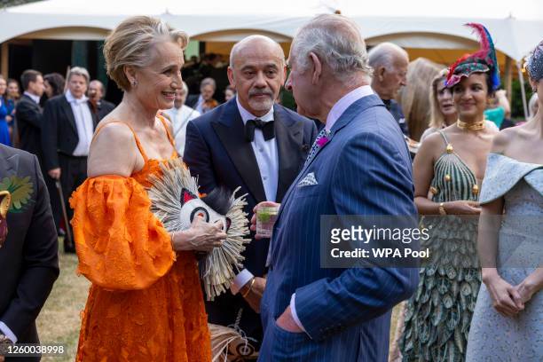 King Charles III speaks with Christian Louboutin and Kristin Scott Thomas during the Animal Ball at Lancaster House to mark the 20th anniversary of...