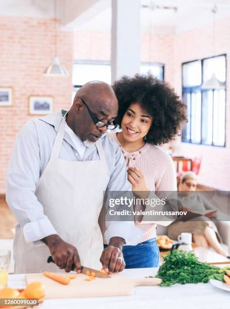 lovely mutli generation family cooking together - father in law stock pictures, royalty-free photos & images