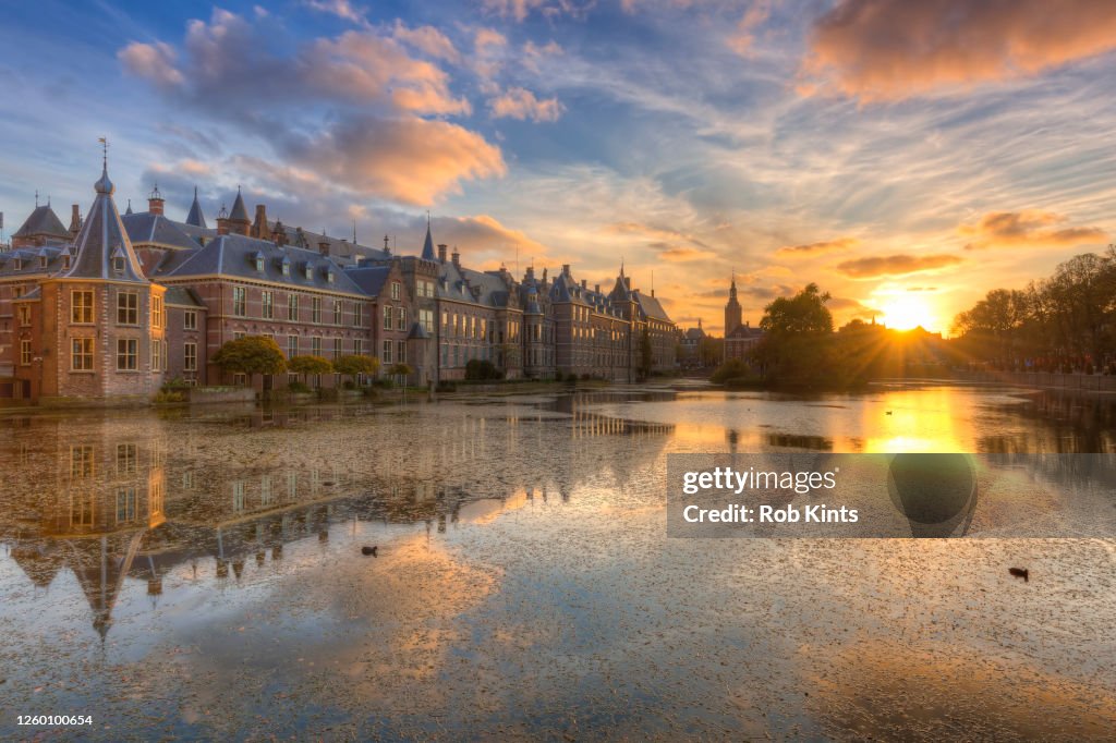 Dutch Houses of Parliament ( Het Torentje and Binnenhof ) in The Hague reflected in the Court Pond ( Hofvijver ) at Sunset