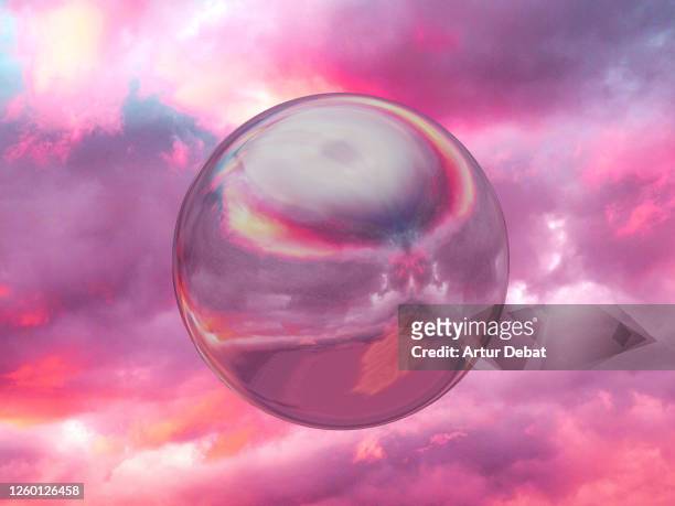 perfect metallic sphere reflecting sunset sky levitating in dramatic sky. - romantic sky stock pictures, royalty-free photos & images