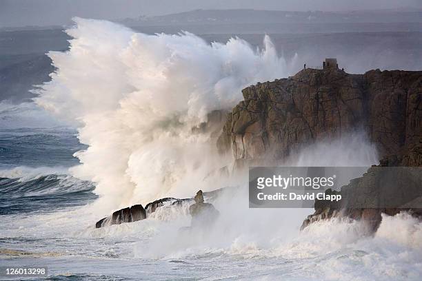 winter storms hit the rocky coastline with monumental force at land's end in cornwall. - roccia foto e immagini stock