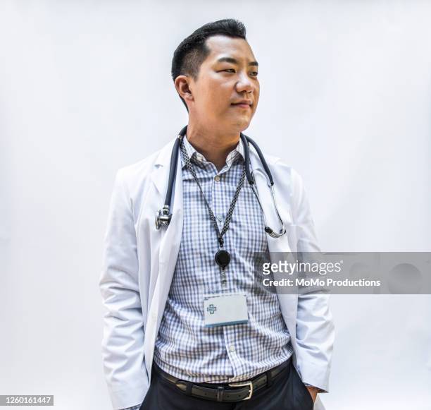 studio portrait of doctor/healthcare worker - three quarter length stock pictures, royalty-free photos & images