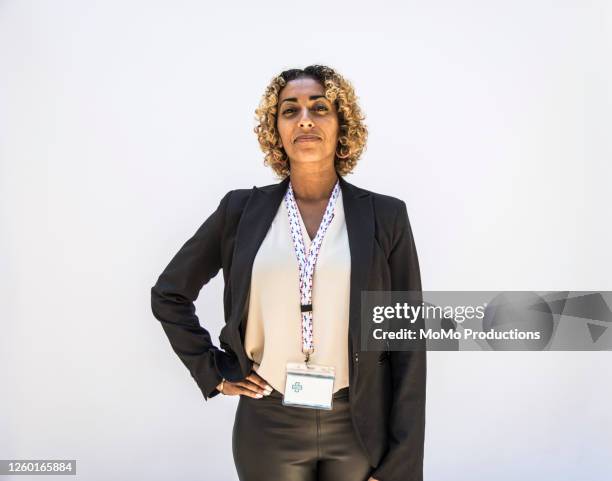 studio portrait of female doctor/healthcare worker - hero stock pictures, royalty-free photos & images