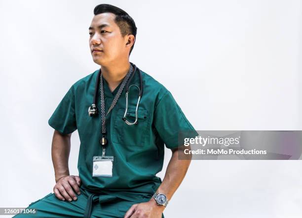 studio portrait of doctor/healthcare worker - three quarter length stock pictures, royalty-free photos & images