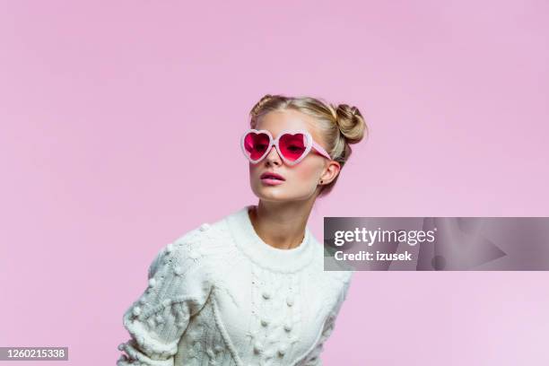 beautiful teenege girl wearing heart shaped sunglasses - pink sunglasses stock pictures, royalty-free photos & images