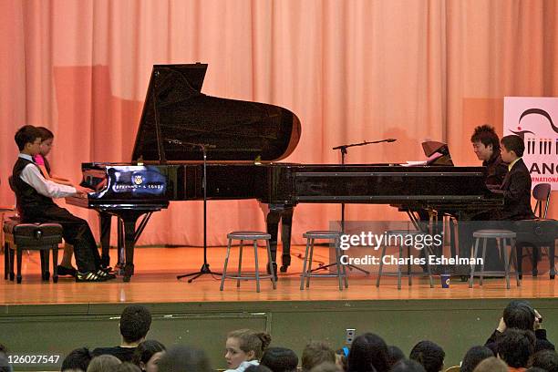 Pianists Derek Wang, Anna Larsen, Lang Lang and Charlie Liu perform at PS 334 - The Anderson School on January 3, 2011 in New York City.