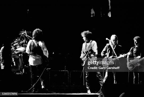 American Folk and Pop musician Bob Dylan plays guitar as he performs onstage during the 'True Confessions Tour' at Madison Square Garden, New York,...