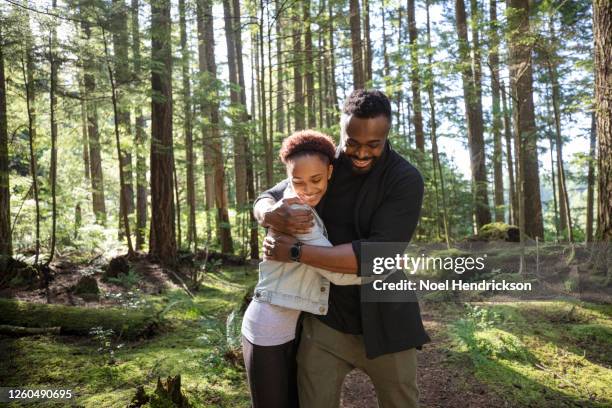 dad and daughter sharing a happy family moment in the forest - lean in collection stock pictures, royalty-free photos & images