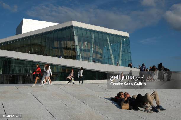 People relax outside the Oslo Opera House during the novel coronavirus pandemic on July 27, 2020 in Oslo, Norway. Norway has fared comparatively well...
