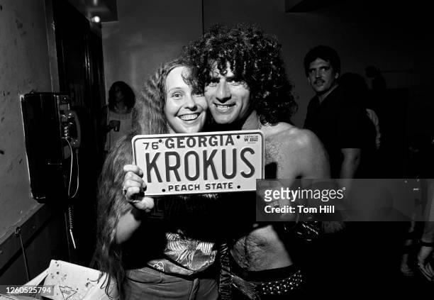 Fan and frontman Marc Storace of the Swiss band Krokus pose with her Krokus license plate after Krokus performed at the Fabulous Fox Theater on July...