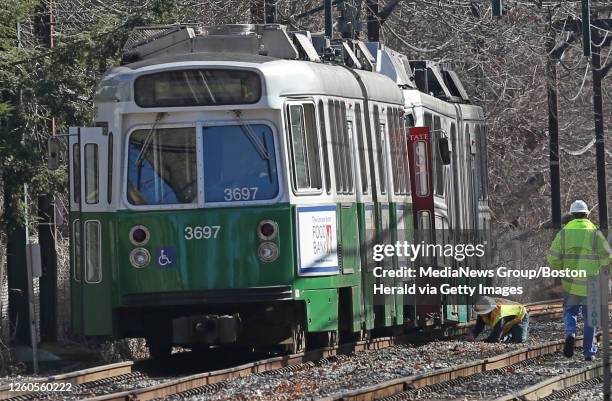 Worker examines a Green Line trolley after it derailed near the Beaconsfield stop on February 5, 2019 in Brookline, Massachusetts.