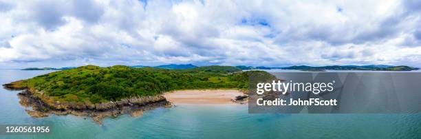 wide aerial panoramic view from the sea of a small beach on the coast of south west scotland - beach wide stock pictures, royalty-free photos & images