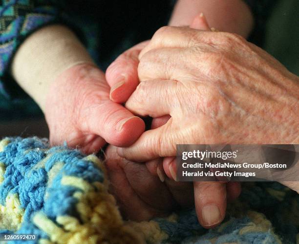 Detail of Claudia Johnson holding hands with her mother Hilma Barber inside J.B. Devlin Nursing Home in Lynn.staff photo:patrick Whittemore svdphoto1...