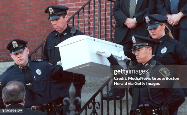 Someville Police Officers Paul Duffy, Steven Carrabino,John Tam, Catherine McDaid carry the casket from services at St. Joseph's in Somerville. Saved...