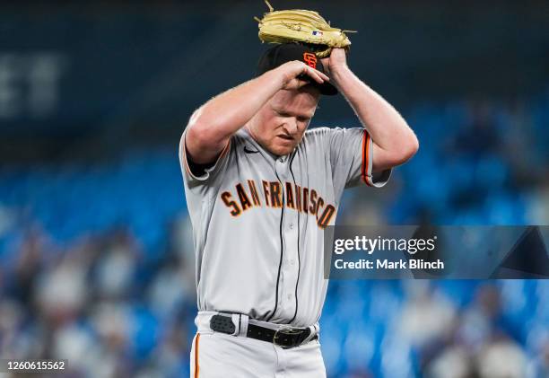 Logan Webb of the San Francisco Giants reacts against the Toronto Blue Jays in the first inning at the Rogers Centre on June 28, 2023 in Toronto,...