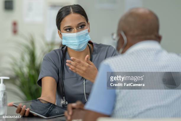 masked medical appointment - covid 19 patient stock pictures, royalty-free photos & images