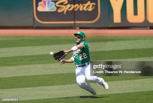 Ramon Laureano of the Oakland Athletics makes a sliding catch taking a hit away from Mike Trout of the Los Angeles Angels in the top of the fith...