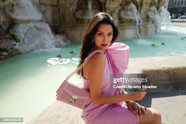 Rebecca Mir wearing Miu Miu shades and bag, Atelier Swarovski earrings and Max Mara dress on July 21, 2020 in Munich, Germany.