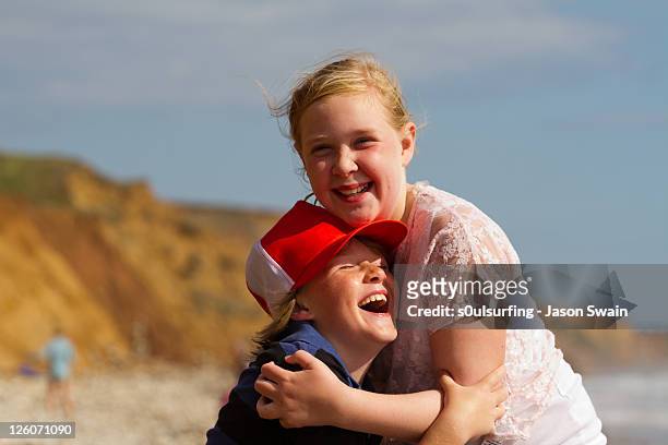 siblings hugging - s0ulsurfing stock pictures, royalty-free photos & images