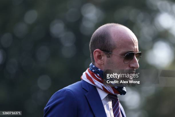 White House senior adviser Stephen Miller walks on the South Lawn after landing aboard Marine One at the White House from a trip with President...
