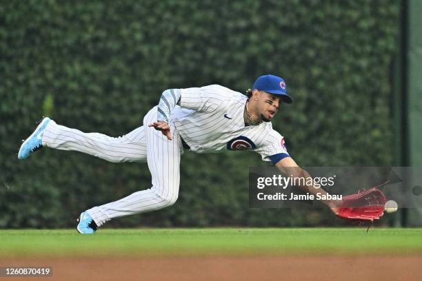 Christopher Morel of the Chicago Cubs is unable to make the catch while diving for a fly ball off the bat of Alec Bohm of the Philadelphia Phillies...