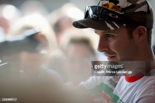 Jonathan Rea of Great Britain and Castrol Honda signs autographs for fans during an autograph signing session at the Paddock Show during the...