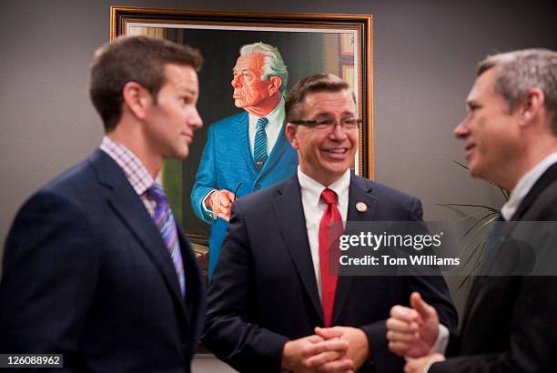 From left, Reps. Aaron Schock, R-Ill., Bobby Schilling, R-Ill., and Sen. Mark Kirk, R-Ill., talk by the newly unveiled portrait of former Senate...