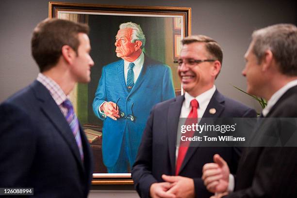 From left, Reps. Aaron Schock, R-Ill., Bobby Schilling, R-Ill., and Sen. Mark Kirk, R-Ill., talk by the newly unveiled portrait of former Senate...