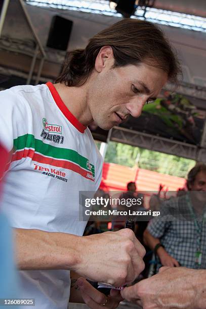 Ruben Xaus of Spain and Castrol Honda signs autographs for fans during an autograph signing session at the Paddock Show during the Superbike World...