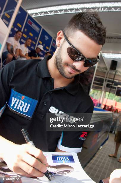 Michel Fabrizio of Italy and Team Suzuki Alstare signs autographs for fans during an autograph signing session at the Paddock Show during the...