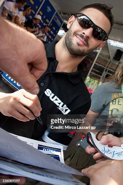 Michel Fabrizio of Italy and Team Suzuki Alstare signs autographs for fans during an autograph signing session at the Paddock Show during the...