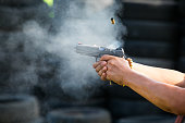 Shooting from a pistol. Reloading the gun. The man is aiming at the target