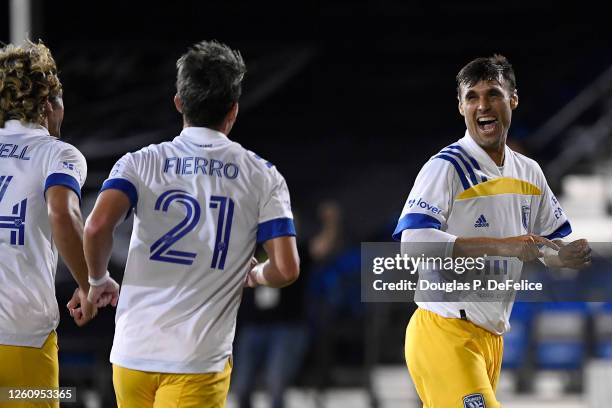 Chris Wondolowski of San Jose Earthquakes celebrates with teammates after scoring the fourth goal of his team during a round of 16 match of the MLS...