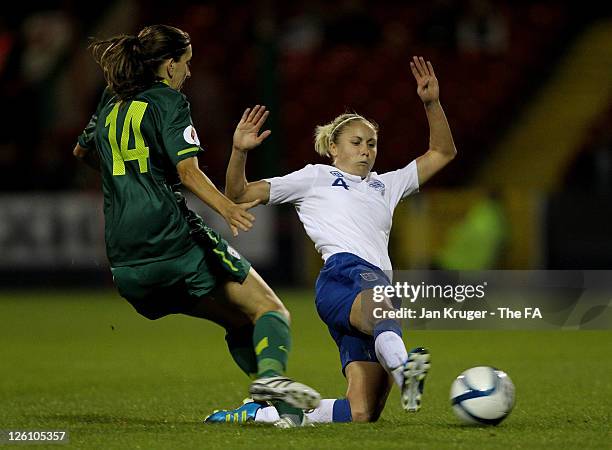 Steph Houghton of England slides in for a tackle on Anja Milenkovic of Slovenia during the UEFA Women's Euro 2013 Qualifier match between England and...