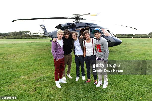 Niall Horan, Louis Tomlinson, Harry Styles, Liam Payne and Zayn Malik of One Direction travel in a luxury helicopter to Glasgow, Manchester and...