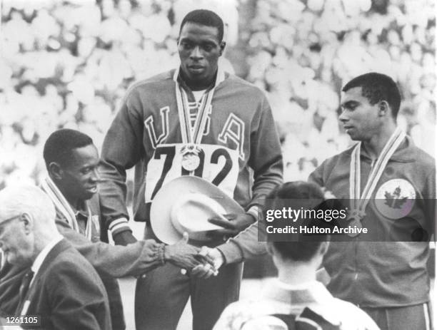 United States athlete Robert Hayes after receiving his gold medal for winning the Men’s 100 metre final at the 1964 Tokyo Olympic Games with a new...