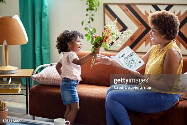 child expressing gratitude and love on mother’s day - giving flowers stock pictures, royalty-free photos & images