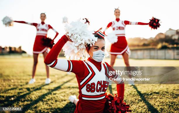 cheerleader doing sport with face mask - sports uniform stock pictures, royalty-free photos & images