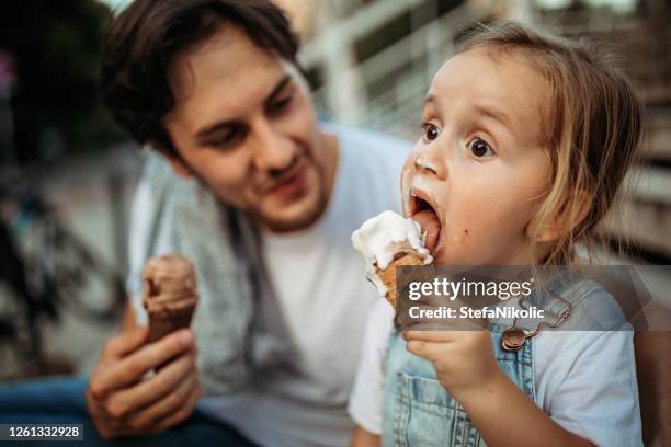 messy girl - girl eating messy ice cream cone stock pictures, royalty-free photos & images