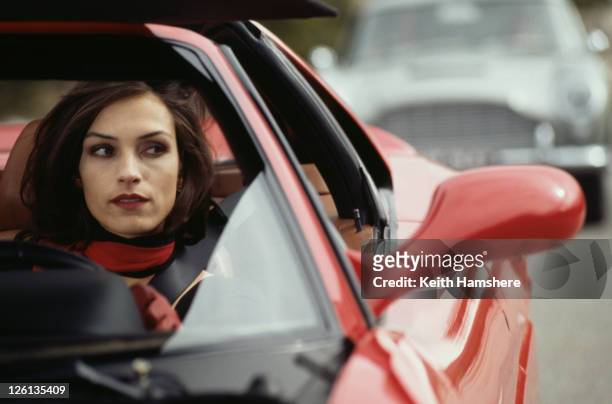 Dutch-born actress Famke Janssen driving a Ferrari F355 GTS as the villainous Xenia Onatopp, in the James Bond film 'GoldenEye', 1995.