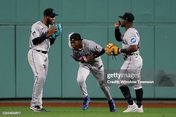 Bryan De La Cruz, Jazz Chisholm Jr. #2 and Jonathan Davis of the Miami Marlins celebrate a 6-2 win over the Boston Red Sox at Fenway Park on June 28,...